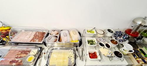 a refrigerator filled with lots of different types of food at Hotel B4 in Oradea