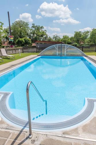 a large swimming pool with a clear blue water at Pension Cäcilia in Pöllau