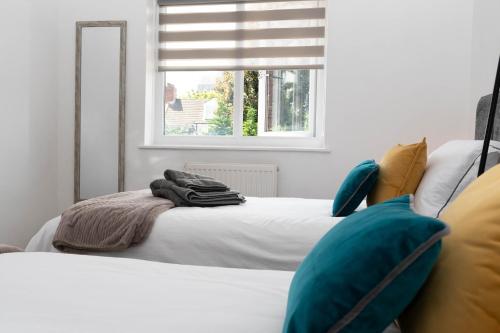a bedroom with two beds and a window at Hale Lodge in London