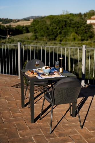 a table and chairs with food on a patio at Hortus Natural Living in Todi