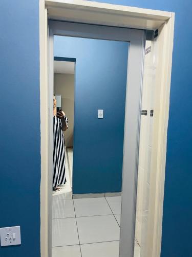 a person taking a picture of a mirror in a bathroom at Moh Ville Guest House in Maseru