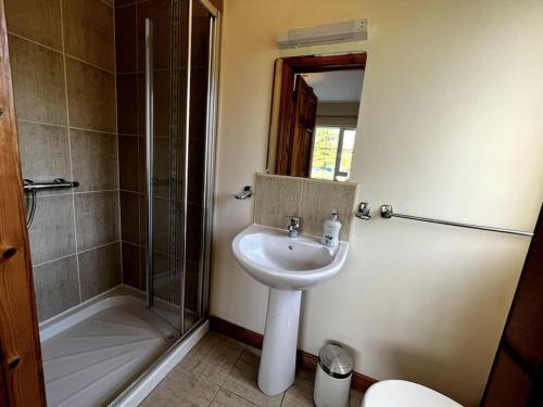 a bathroom with a sink and a shower at Drumbar Lodge in Carterʼs Bridge