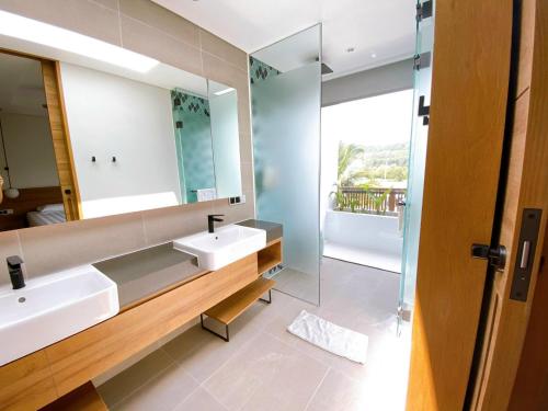 a bathroom with two sinks and a mirror at Phoenix Pool Villa Phu Quoc in Phú Quốc