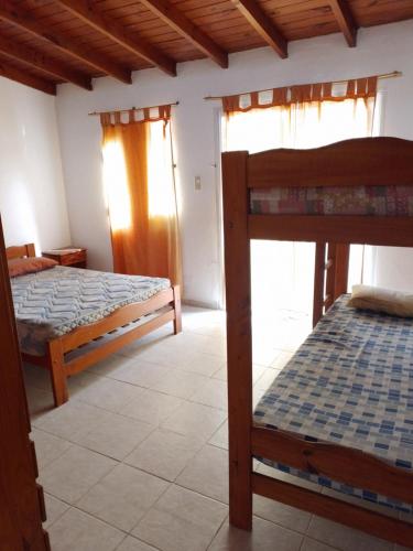 a bedroom with two bunk beds and a window at Alojamientos frente al Mar Complejo "El Estar De La Costa" in San Clemente del Tuyú