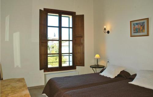 a bedroom with a bed and a window at Cozy Home In Llub With Wifi in Llubí