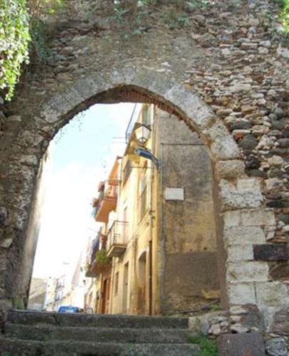 an arch in a stone archway over a building at St. Michele b&b in Patti