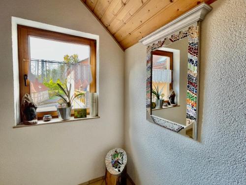 a room with two mirrors on the wall at Zur Glashütte Landpension in Fabrikschleichach