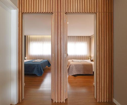 a room with two beds and two windows at Music Apartment I in Porto