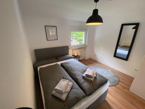 a bedroom with a bed with two pillows on it at Apartments-Badharzburg / Ferienwohnung im Zentrum in Bad Harzburg