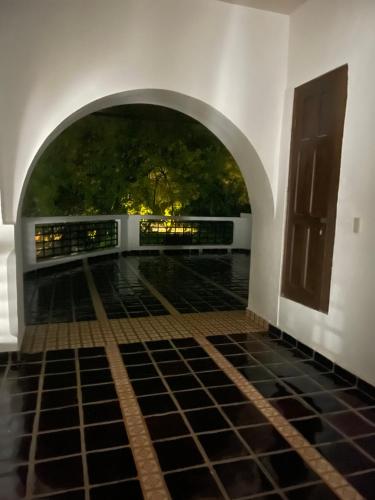 an archway leading to a patio with a tree at Casa Praxedis in Santiago