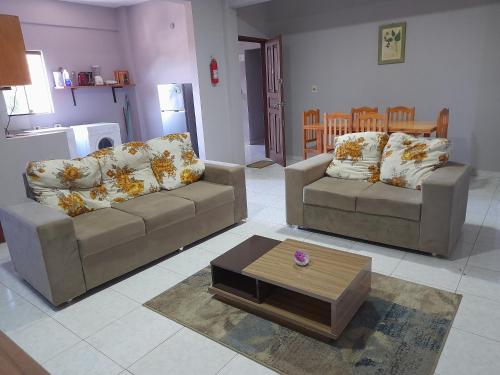 Una sala de estar con dos sofás y una mesa de café. en Hotel André, en San Lorenzo