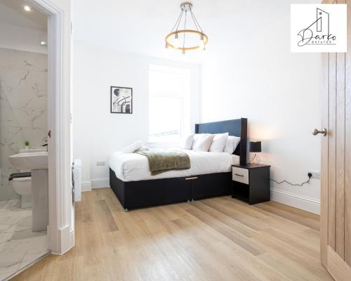 a bedroom with a bed and a sink in it at Apartment 3 - Beautiful 1 Bedroom Apartment Near Manchester in Worsley