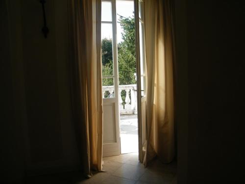 an open door with a view of a yard at Villa Franca in Franciacorta in Passirano