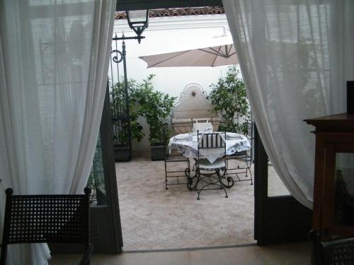 an open door to a patio with a table and an umbrella at Villa Franca in Franciacorta in Passirano