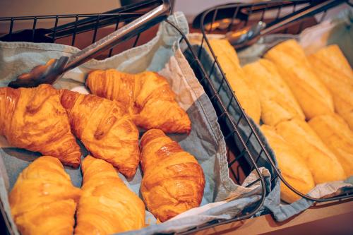 a basket full of croissants and breads at B&B HOTEL Metz Est Technopole Pôle Santé in Ars-Laquenexy