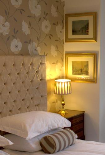 a bedroom with a bed with a headboard and a lamp at The Georgian Town House Hotel in Liverpool