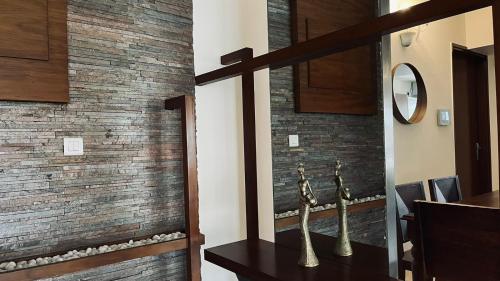 a dining room with a brick wall and a table at LUHO Grande in Bengaluru