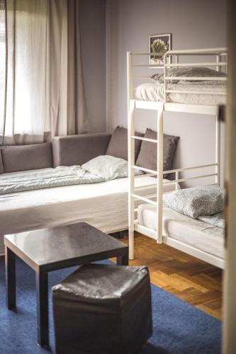 a living room with bunk beds and a couch at 4 Couples & 4 Friends Hostel in Krakow