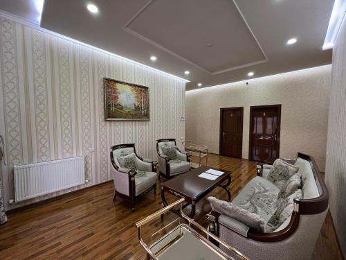a living room with three chairs and a table at MOUNTAIN VIEW SAMARKAND in Samarkand