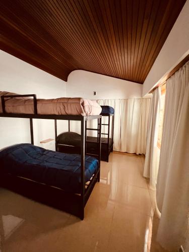a room with two bunk beds and a window at Black Star Art Hostel in Neuquén