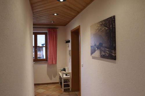 un pasillo con una pintura en la pared y una ventana en Ferienhaus Pfeiffer, en Schwangau