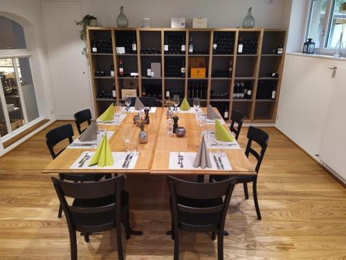 a conference room with a large wooden table and chairs at Gasthaus Meinradsberg in Einsiedeln