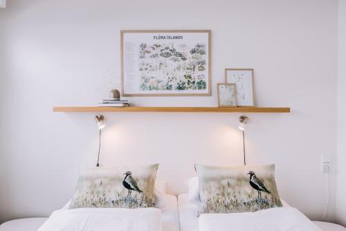 a shelf above a bed with two pillows at Hlid Bed and Breakfast in Myvatn