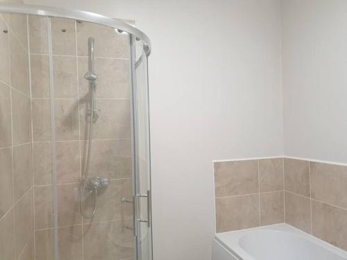 a bathroom with a shower with a glass door at Victoria Lodge Woodhall Spa in Woodhall Spa