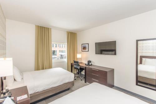 a hotel room with two beds and a desk at Ohio House Motel in Chicago