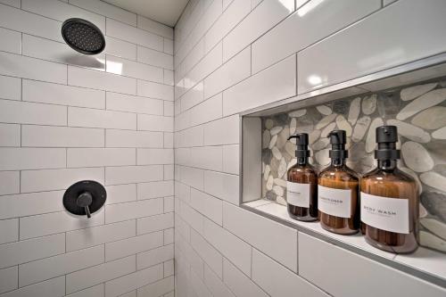 a bathroom with three bottles of wine on a shelf at Updated Brevard Home - Close to Downtown! in Brevard