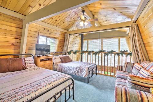 a bedroom with two beds and a tv in a cabin at Château Forêt with Hiking Trail Access Nearby in Big Bear City