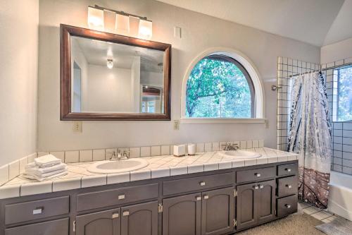 a bathroom with two sinks and a large mirror at Deck + Grill: Mtn Haven in Stanislaus Nat'l Forest in Arnold