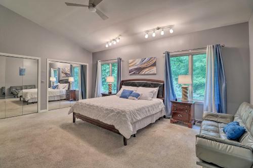 a bedroom with a bed and a couch and windows at Unique Pet-Friendly Dover Home with Skylight in Dover
