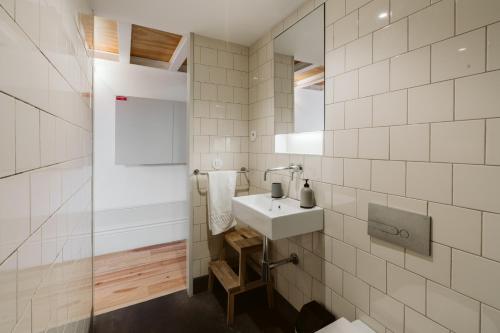 Un baño blanco con lavabo y ducha. en Step In Porto Apartments, en Oporto