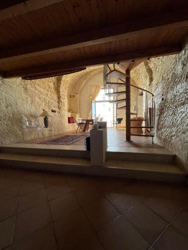 a room with a staircase in a stone building at Admirari in Tropea