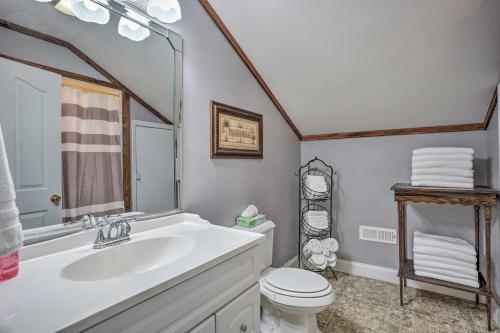 a bathroom with a sink and a toilet and a mirror at Spacious Group-Friendly Georgia Home on Lake in Trenton