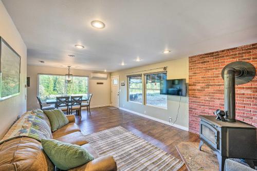 a living room with a couch and a brick wall at Dreamy Riverside Cabin with Fireplace and Grill in Concrete