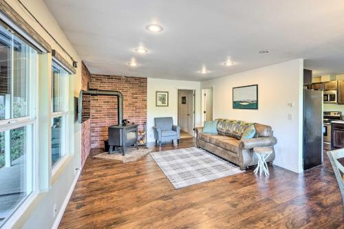 a living room with a couch and a fireplace at Dreamy Riverside Cabin with Fireplace and Grill in Concrete