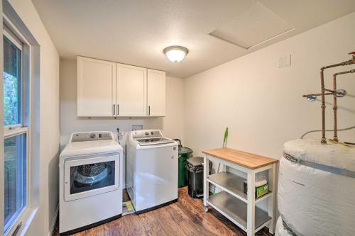 a laundry room with a washing machine and a washer at Dreamy Riverside Cabin with Fireplace and Grill in Concrete