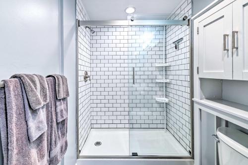y baño con ducha de azulejos blancos. en Cozy and Walkable Delmar Getaway with Fire Pit!, 