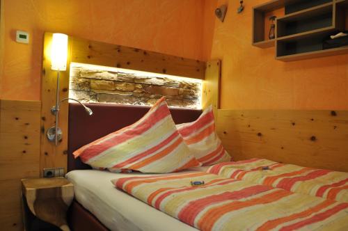 a bedroom with a bed with two pillows on it at Himmelsbögen und Apartments mit Seeblick und Alleinlage in Weissensee