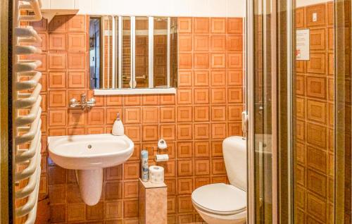 a bathroom with a toilet and a sink at Ranczo in Mogilany