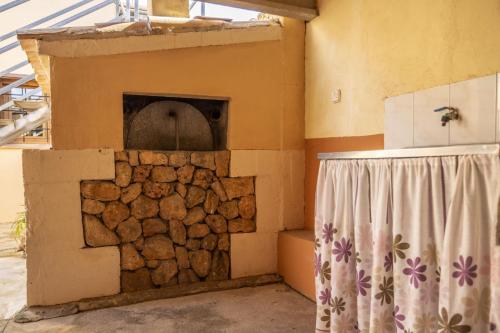 a stone oven in a room with a window at Finca Can Tomeu 454 in Inca