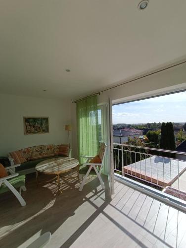 a living room with a couch and a balcony at Ferienwohnung zum Wohlfühlen in Lengerich