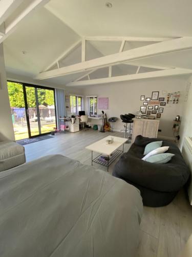 a bedroom with a large bed and a table at Stonebury Lodge in Coventry