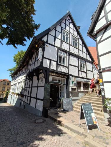 a black and white building with a sign in front at Ferienwohnung zum Wohlfühlen in Lengerich