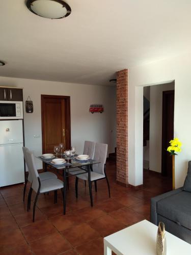 a kitchen and living room with a table and chairs at ELE HAUSE Tropical Paradise in Tarajalejo