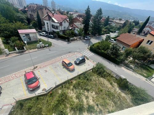 two cars parked on a street in a city at Apartment Lazar in Skopje