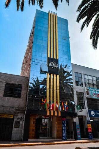 a building with a sign on the side of it at Hotel Dubái in Tacna