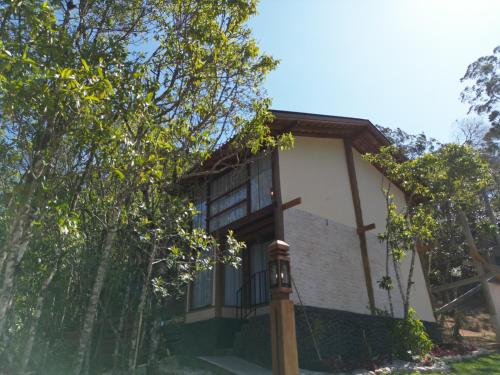 a house with a balcony on the side of it at CHALÉS LUAR DO PICO in Santo Antônio do Pinhal
